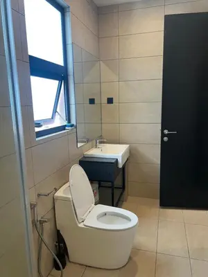 a bathroom with a toilet and a sink at Opus Residences KL Malaysia in Kuala Lumpur
