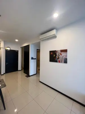 a hallway with a white wall with a painting on it at Opus Residences KL Malaysia in Kuala Lumpur