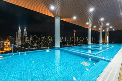 a swimming pool on top of a building with a city skyline at The Colony and The Luxe Premier Suites Kuala Lumpur in Kuala Lumpur