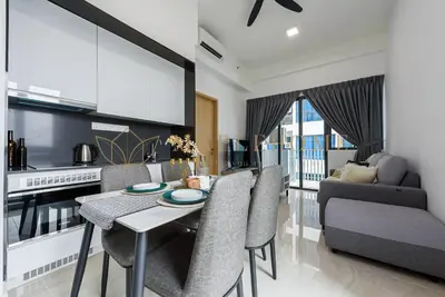 a kitchen and living room with a table and chairs at The Colony and The Luxe Premier Suites Kuala Lumpur in Kuala Lumpur