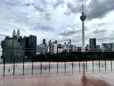 a view of a city skyline with the space needle at #16 M101 Dang Wangi KLCC View Pool By Livin in Kuala Lumpur