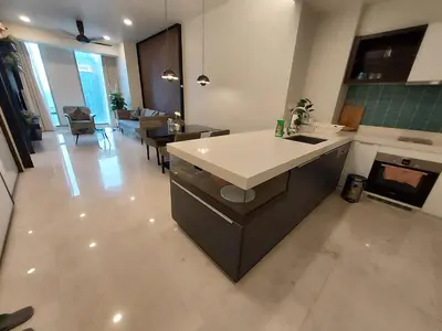 a kitchen and living room with a counter and a table at Kuala Lumpur City Center Tropicana The Residence in Kuala Lumpur