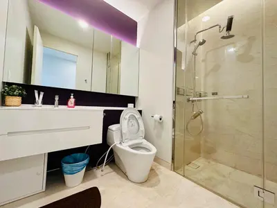 a bathroom with a toilet and a glass shower at Kuala Lumpur City Center Tropicana The Residence in Kuala Lumpur