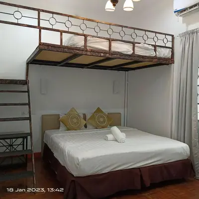 a bedroom with a bunk bed with white sheets at Cheras Homestay Family room with Private Bathroom in Kuala Lumpur