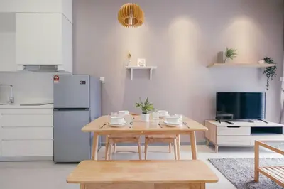 a kitchen with a table and a refrigerator at Muji Home 2BR 4Pax Southlink Nexus Bangsar South in Kuala Lumpur