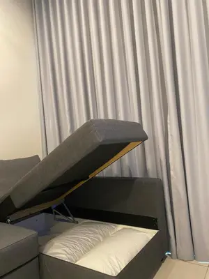 a bed in front of a window with curtains at Datum Jelatek Sky Residence KLCC SkyRing Linked to LRT and Mall in Kuala Lumpur