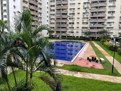 a swimming pool in front of a large apartment building at Suasana Stay & Homestay Sentul Utama Kuala Lumpur 3R3BR 2AC 2 Car park-Netflix-WIFI-Pool View in Kuala Lumpur
