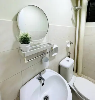 a bathroom with a sink and a mirror and a toilet at Suasana Stay & Homestay Sentul Utama Kuala Lumpur 3R3BR 2AC 2 Car park-Netflix-WIFI-Pool View in Kuala Lumpur