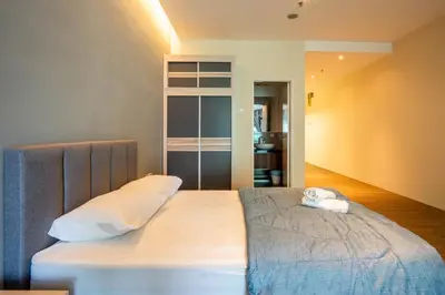 a bedroom with a bed with a teddy bear on it at Bangsar Trade Centre by Airhost in Kuala Lumpur