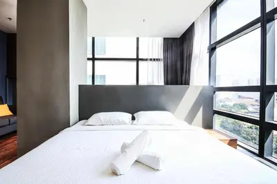a bedroom with a large white bed with two white pillows at Bangsar Trade Centre by Airhost in Kuala Lumpur