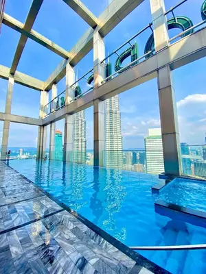 a pool in a building with a view of the city at Tropicana The Residence Klcc By Sky World in Kuala Lumpur