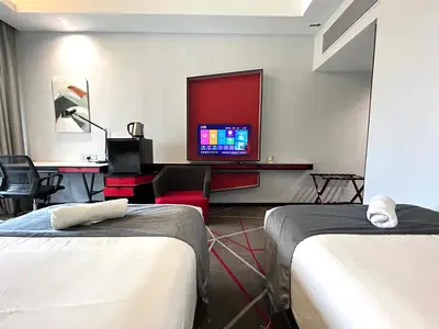 a hotel room with two beds and a flat screen tv at #23 KL towel view twin bed suites @ infinity pool in Kuala Lumpur