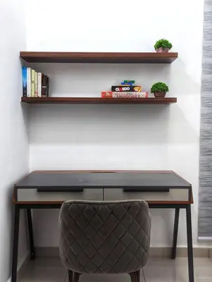 a desk with a chair in front of a wall at Legasi 3-bedroom condo - 5 mins walk to KLCC in Kuala Lumpur