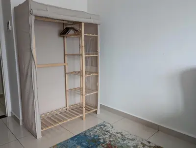 a room with a book shelf in the corner at Legasi 3-bedroom condo - 5 mins walk to KLCC in Kuala Lumpur