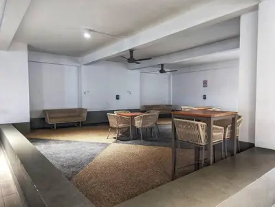 an empty room with tables and chairs in it at Legasi 3-bedroom condo - 5 mins walk to KLCC in Kuala Lumpur