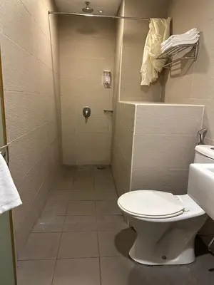 a small bathroom with a toilet and a shower at Uptown Chinatown in Kuala Lumpur