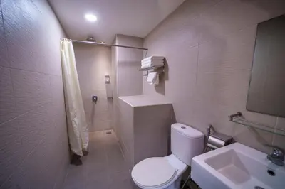 a bathroom with a toilet and a shower and a sink at Uptown Chinatown in Kuala Lumpur