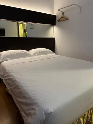 a large white bed sitting in a bedroom at Uptown Chinatown in Kuala Lumpur