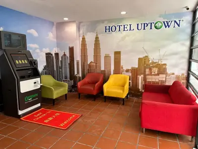 a hotel uptown waiting room with colorful chairs and a ticket machine at Uptown Chinatown in Kuala Lumpur