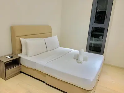 a bedroom with a bed with two candles on it at Star Sky Park KLCC in Kuala Lumpur