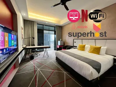 a bedroom with a bed and a large screen tv at #211 M101 Dang Wangi KLCC View Pool By Livin in Kuala Lumpur
