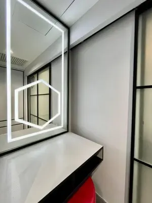 a mirror on the side of a room with a red chair at #211 M101 Dang Wangi KLCC View Pool By Livin in Kuala Lumpur
