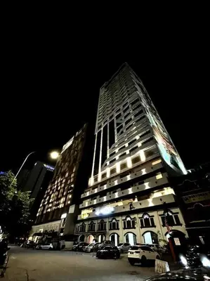 a tall building at night with cars parked in front of it at #211 M101 Dang Wangi KLCC View Pool By Livin in Kuala Lumpur