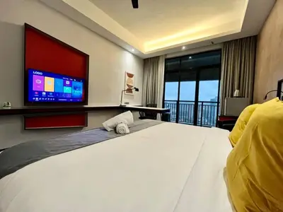 a bedroom with a large white bed and a tv at #211 M101 Dang Wangi KLCC View Pool By Livin in Kuala Lumpur