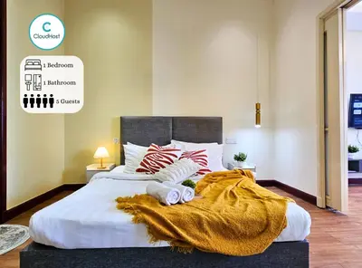 a bedroom with a large bed with a blanket on it at Homestay Heart of Bukit Bintang Walk to Monorail & LRT St by Cloud Host in Kuala Lumpur