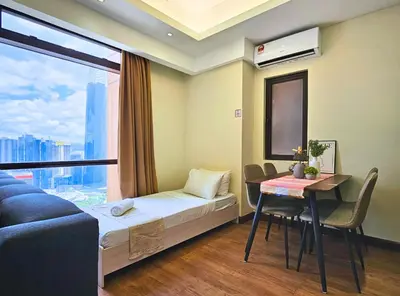 a room with a bed and a table and a window at Homestay Heart of Bukit Bintang Walk to Monorail & LRT St by Cloud Host in Kuala Lumpur