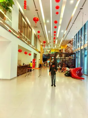a man walking through a shopping mall with red lanterns at Summer Suites by Moon Orchid in Kuala Lumpur