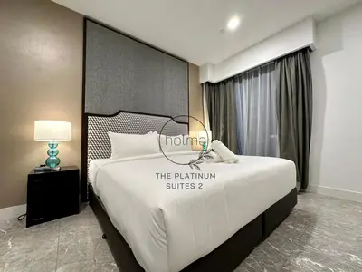 a bedroom with a large bed with a sign on it at The Platinum 2 Kuala Lumpur by HOLMA in Kuala Lumpur