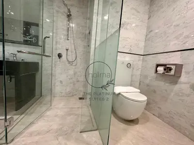 a bathroom with a toilet and a glass shower at The Platinum 2 Kuala Lumpur by HOLMA in Kuala Lumpur