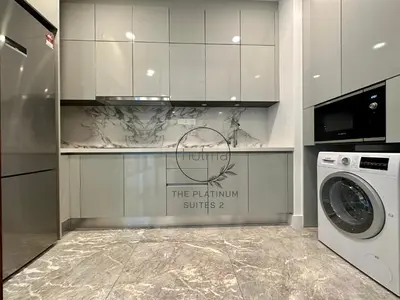 a kitchen with a washing machine and a sign at The Platinum 2 Kuala Lumpur by HOLMA in Kuala Lumpur