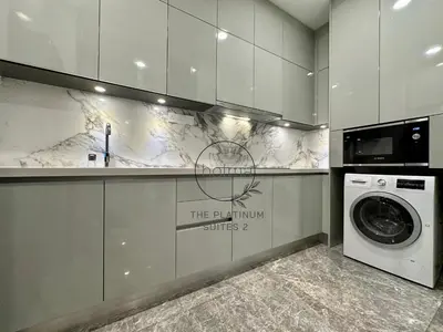 a kitchen with a washing machine and a sign on the wall at The Platinum 2 Kuala Lumpur by HOLMA in Kuala Lumpur