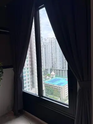 a window in a room with a view of a building at Arcoris Soho 1-4PAX COZY HOME in Kuala Lumpur