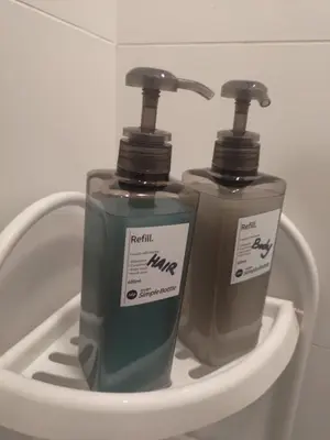 two bottles of soap sitting in a holder at Arcoris Soho 1-4PAX COZY HOME in Kuala Lumpur