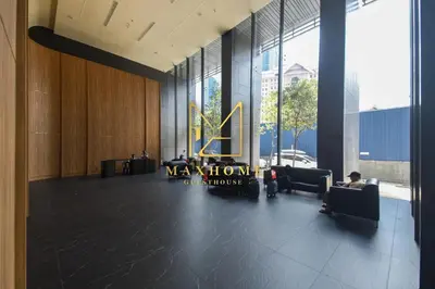 a lobby with a waiting room with a man sitting in a chair at Maxhome Premium at Dorsett Bukit Bintang in Kuala Lumpur