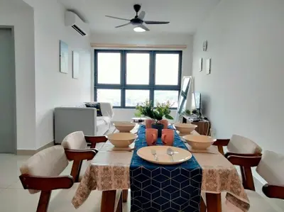 a living room with a table with chairs and a couch at M Vertica Residence I HomeBrickz in Kuala Lumpur