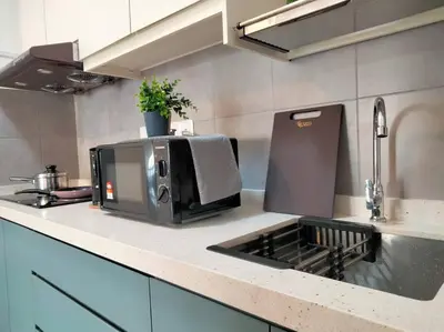 a microwave sitting on a counter in a kitchen at M Vertica Residence I HomeBrickz in Kuala Lumpur