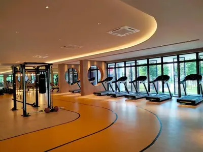 a gym with a row of exercise equipment in a room at M Vertica Residence I HomeBrickz in Kuala Lumpur