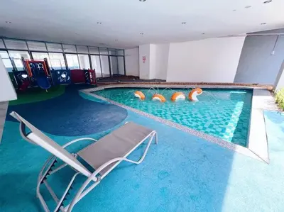 a swimming pool with a chair in the middle of it at [PROMO]Connected train 2 Bedroom ABOVE MALL (22) in Kuala Lumpur