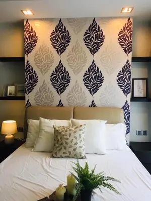 a bedroom with a white bed with a blue and white wall at Kuala Lumpur Bukit Bintang LaLaport Serviced Suite KLCC in Kuala Lumpur