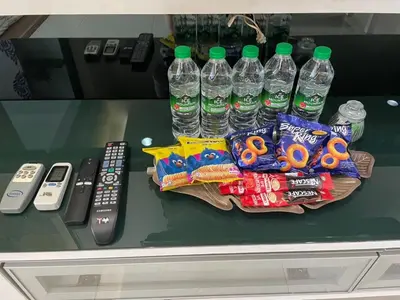 a table topped with bottles of water and snacks at Kuala Lumpur Bukit Bintang LaLaport Serviced Suite KLCC in Kuala Lumpur