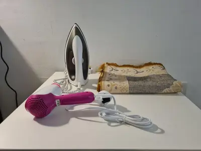 a pink hair dryer sitting on top of a table at 1 min Next to LRT CHERAS 68 with Shared Area in Kuala Lumpur