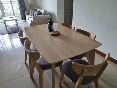 a wooden table with chairs and a bottle of wine on it at 1 min Next to LRT CHERAS 68 with Shared Area in Kuala Lumpur