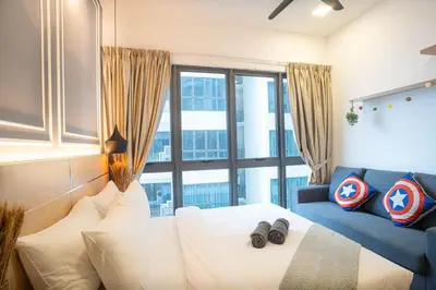 a bedroom with a white bed and a blue couch at The Colony By Infinitum Best Pool View KLCC TRX Merdeka 118 KL Tower in Kuala Lumpur