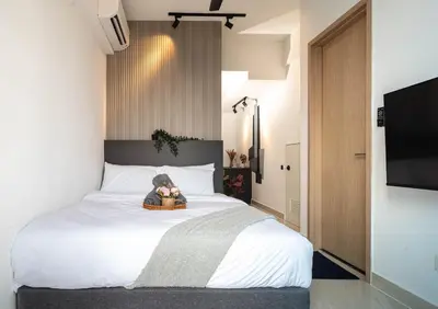 a bedroom with a bed with a teddy bear on it at The Colony By Infinitum Best Pool View KLCC TRX Merdeka 118 KL Tower in Kuala Lumpur