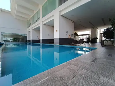 a large swimming pool in a building with blue water at RM020 Bukit Bintang 118 Tower Balcony View in Kuala Lumpur