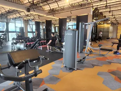 a gym with cardio equipment and people in the background at Infini Suites@ Scarletz Suites KLCC in Kuala Lumpur